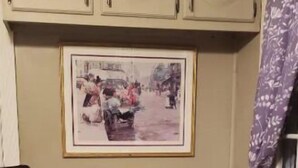 A kitchen with beige cabinets, a framed picture on the wall, a small table, two chairs, and a tiled floor. - THE COZY COTTAGE, A Great place to hang your hat. (Post)