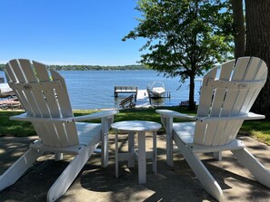 Patio View of the Lake from under the deck. Adirondack chairs adorn the property