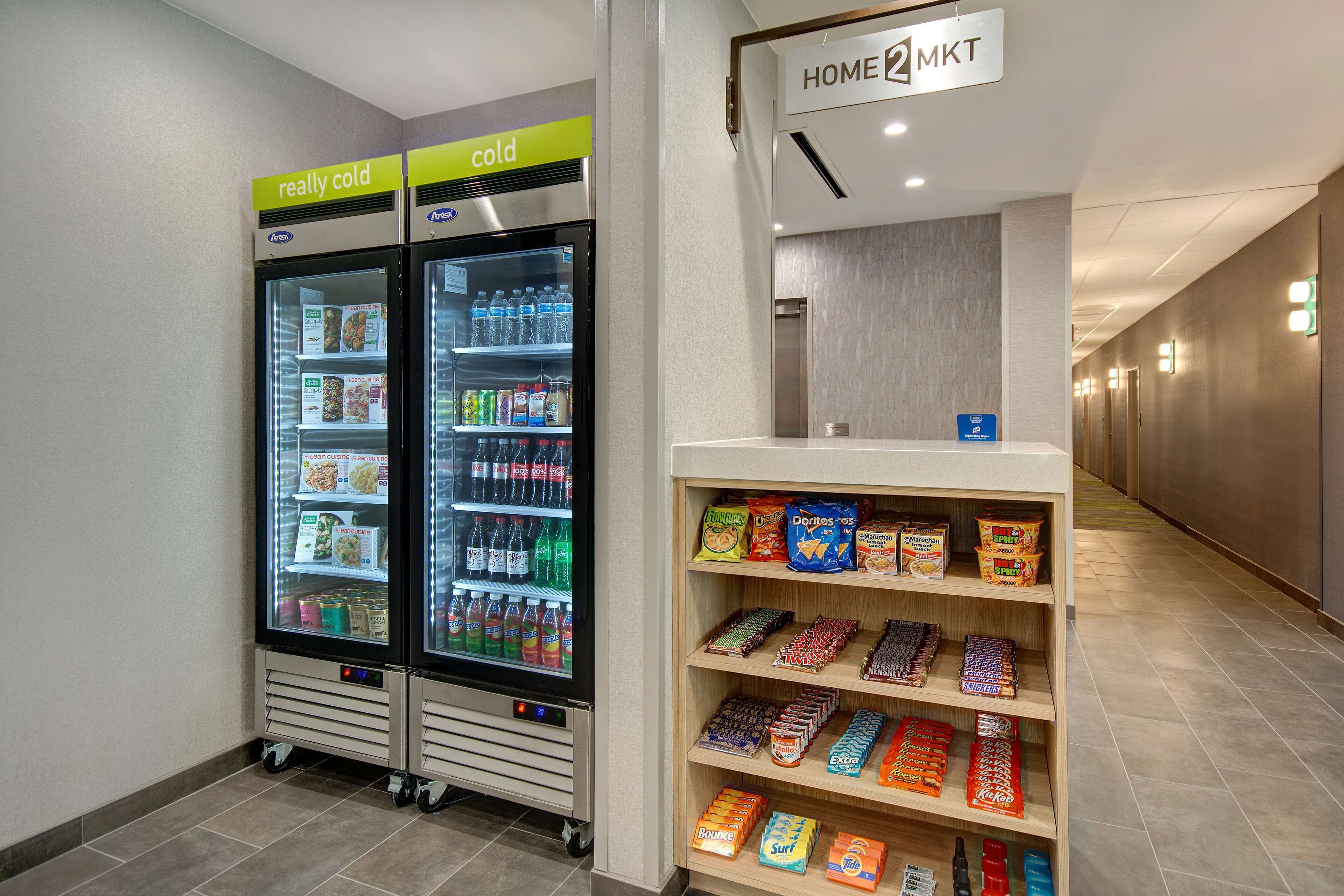 A vending machine with snacks and a refrigerator with beverages.