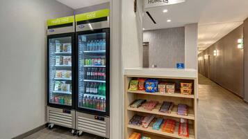 A vending machine with snacks and a refrigerator with beverages.