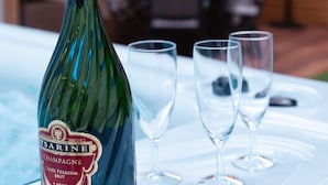 A bottle of champagne on a table with three glasses. - Les Sycomores large 8-person gîte with spa, 5-minute walk from the sea (Ver-sur-Mer)