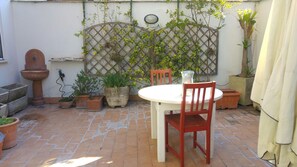 Enjoy a peaceful retreat in this serene patio area, complete with a table for dining or relaxation.