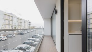 A balcony with a view of parked cars and buildings. - An accomodation very close to Ponta Delgada! (Ponta Delgada)