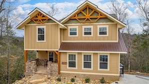A two-story house with a stone foundation, a front porch, and a sign that reads "SECURITY PEAK." - Serenity Peak (Gatlinburg)