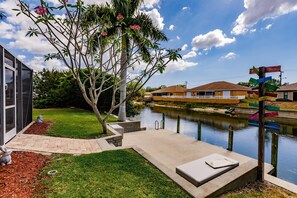 Enjoy a serene view of the calm water body from the comfort of a peaceful seating area.