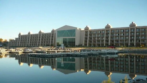 A large hotel with multiple floors and a central glass facade. - Waterfront Parker Strip - Private 50' Dock - Moovalya Keys (Parker)