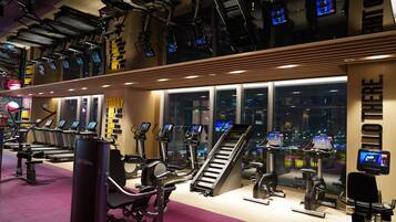 A gym with treadmills, stair climbers, and exercise equipment.