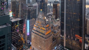 A cityscape with high-rise buildings, a prominent Times Square area, and a large CBS News building.