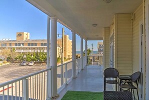 Enjoy a balcony with a view of the surrounding area, featuring two comfortable chairs.