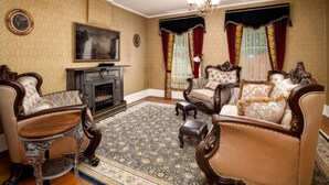 A traditional living room with ornate furniture, a fireplace, and patterned wallpaper. - Stay at the Pre-Civil war home of the Ulysses S. Grant, 18th President of the United States (Galena)