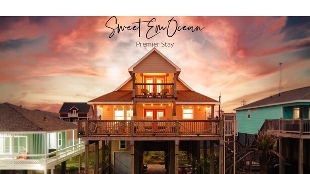 A two-story wooden house with a balcony, a porch, and a deck. - Incredible Ocean Sunrise Views, Sleeps 12, Experienced VRBO Premier 5 STAR Host (Freeport)