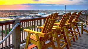 A wooden deck with a railing overlooking the ocean at sunset. - Incredible Ocean Sunrise Views, Sleeps 12, Experienced VRBO Premier 5 STAR Host (Freeport)