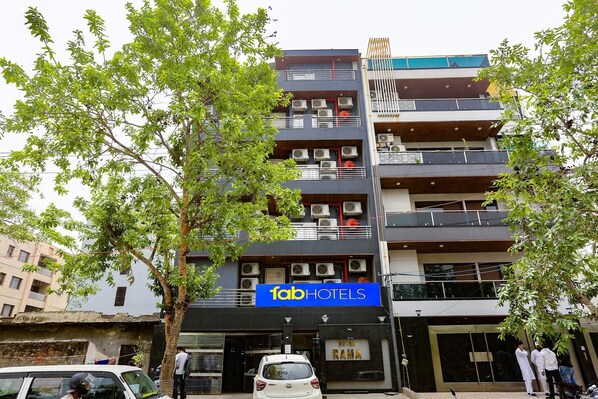 A multi-story building with a sign for 'fab hotels' and a sign for 'Hotel Rama'. - Fabexpress Rama (New Delhi)