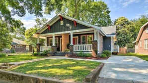 A two-story house with a front porch, brick foundation, and a well-maintained lawn. - NEW! Modern Charlotte Hub in Lockwood Neighborhood (Charlotte)