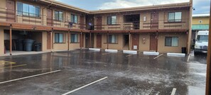 A multi-story building with a covered parking area.