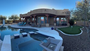 A modern house with a swimming pool, outdoor seating, and a putting green. - Serene Scottsdale Home:Heated Pool,HotTub,FirePit,Putting Green & Mountain Views (Scottsdale)