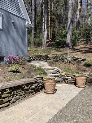 Stroll along the stone pathway to this serene retreat, surrounded by lush greenery and beautiful gardens.
