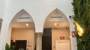 A hotel lobby with a staircase, a reception desk, and a sign indicating the third floor. - Soho Boutique Columela (Cádiz)