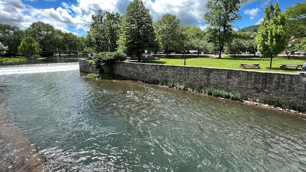 A riverside park with stone walls, picnic tables, and trees. - Historic, Stylish Getaway 2 blocks from Waterfront (Bellefonte)