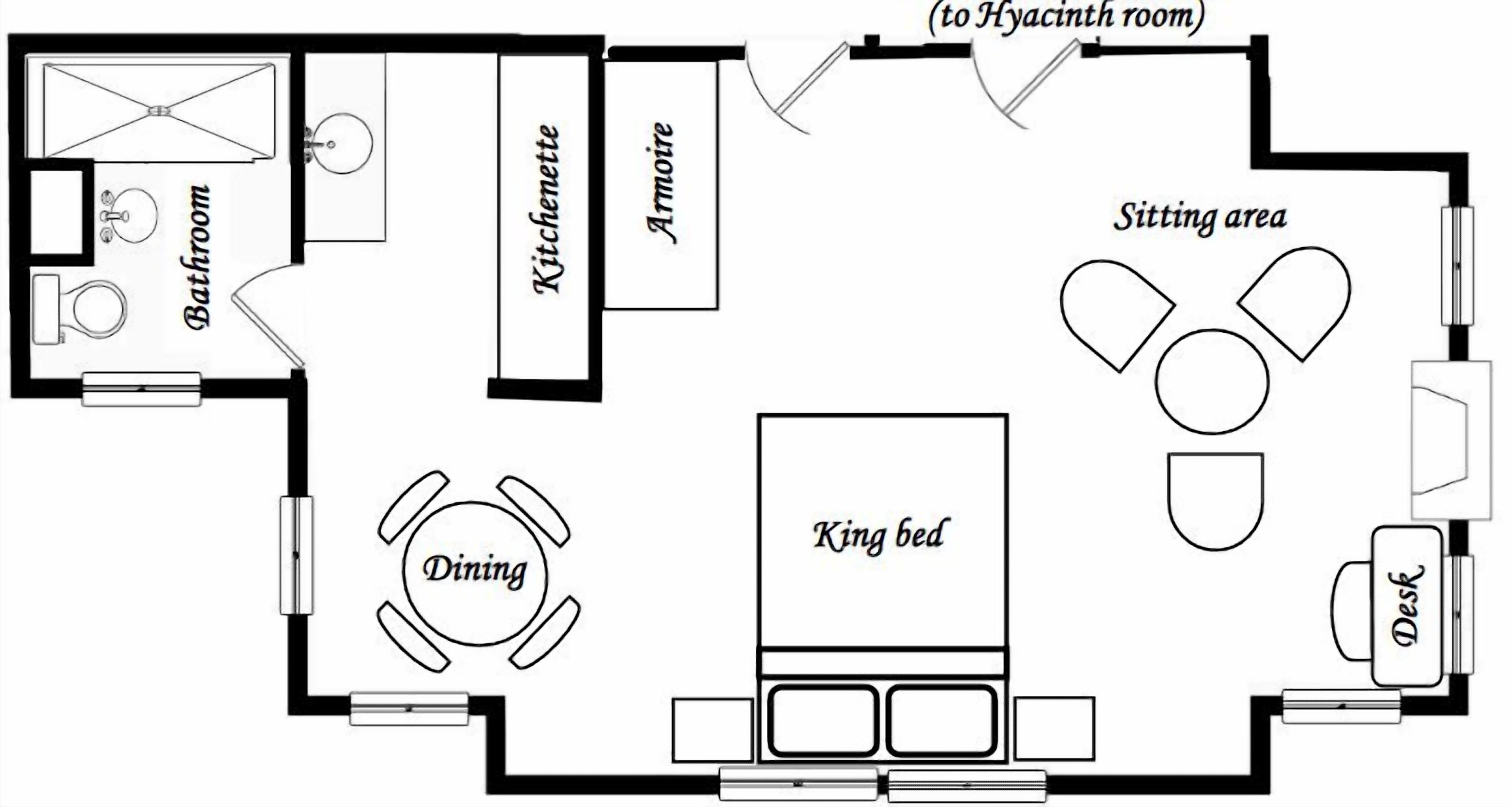 A hotel room layout with a king bed, dining table, kitchenette, bathroom, and sitting area.
