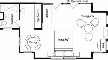 A hotel room layout with a king bed, dining table, kitchenette, bathroom, and sitting area.