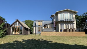A two-story house with a balcony and a separate garage. - Fantastic view and magical sunsets! (Algutsrum)