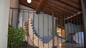 A staircase with a metal railing, a potted plant, and a white umbrella.