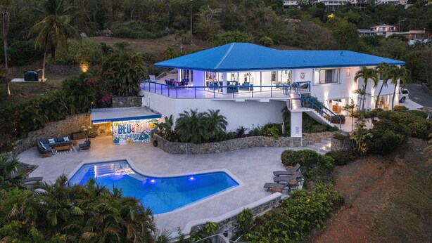 A two-story house with a swimming pool, a covered patio, and a view of the surrounding landscape. - 3 Villas,One Price/ Sleeps 16/ Steam Room/Private Pool/Close to everything Gated (St Thomas)