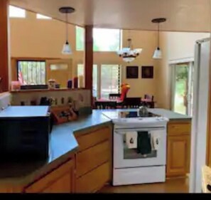 Enjoy cooking in this well-equipped kitchen with a central island, oven, and ample natural light.