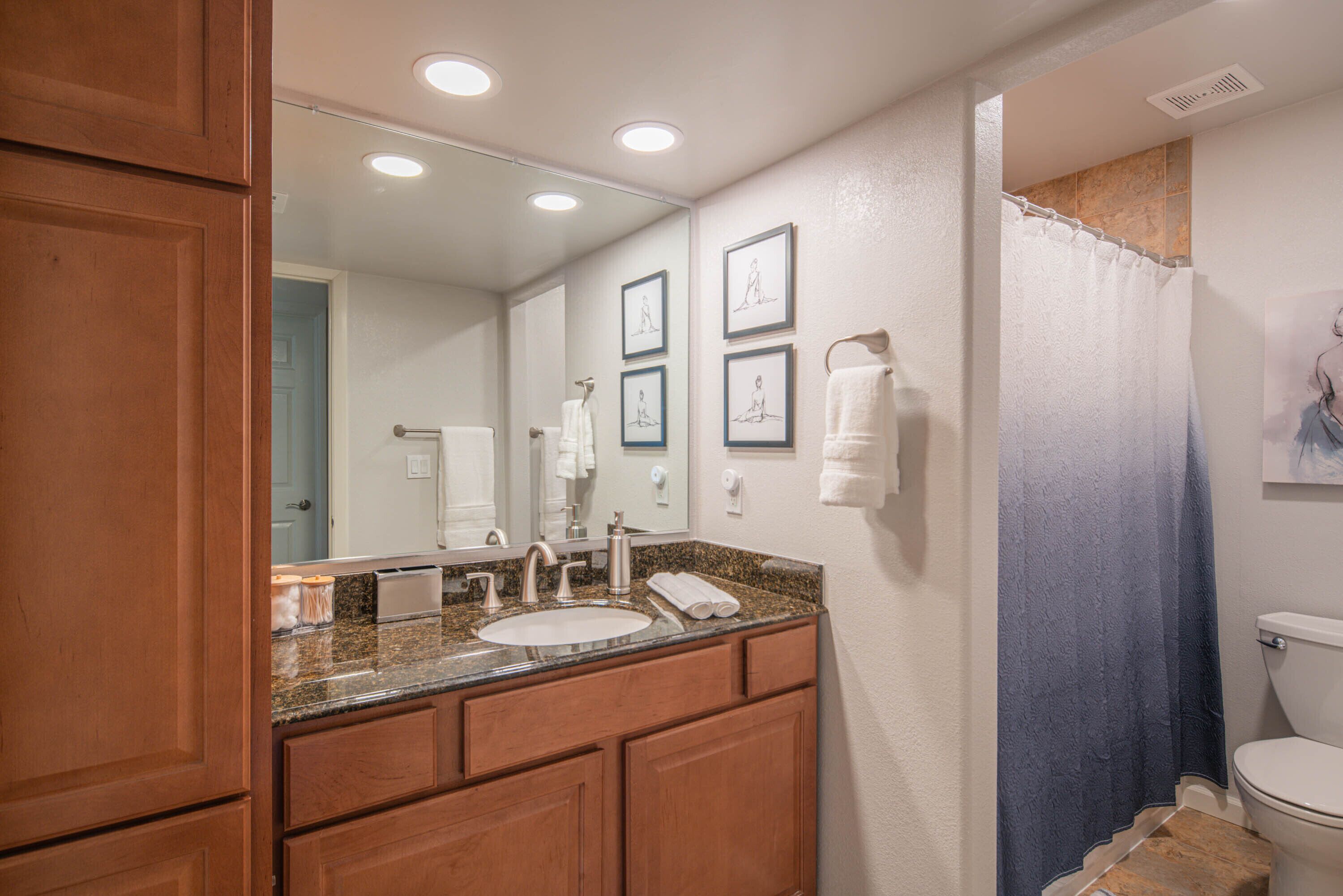 A bathroom with a sink, mirror, and towel rack.