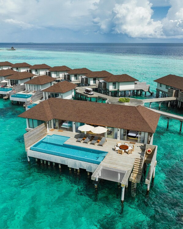 Overwater bungalows with infinity pools, connected by walkways, in a clear turquoise sea. - Avani+ Fares Maldives Resort (Fares)