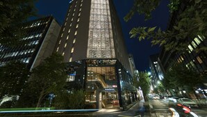 A tall building with a glass facade and a sign for "The Royal Court."