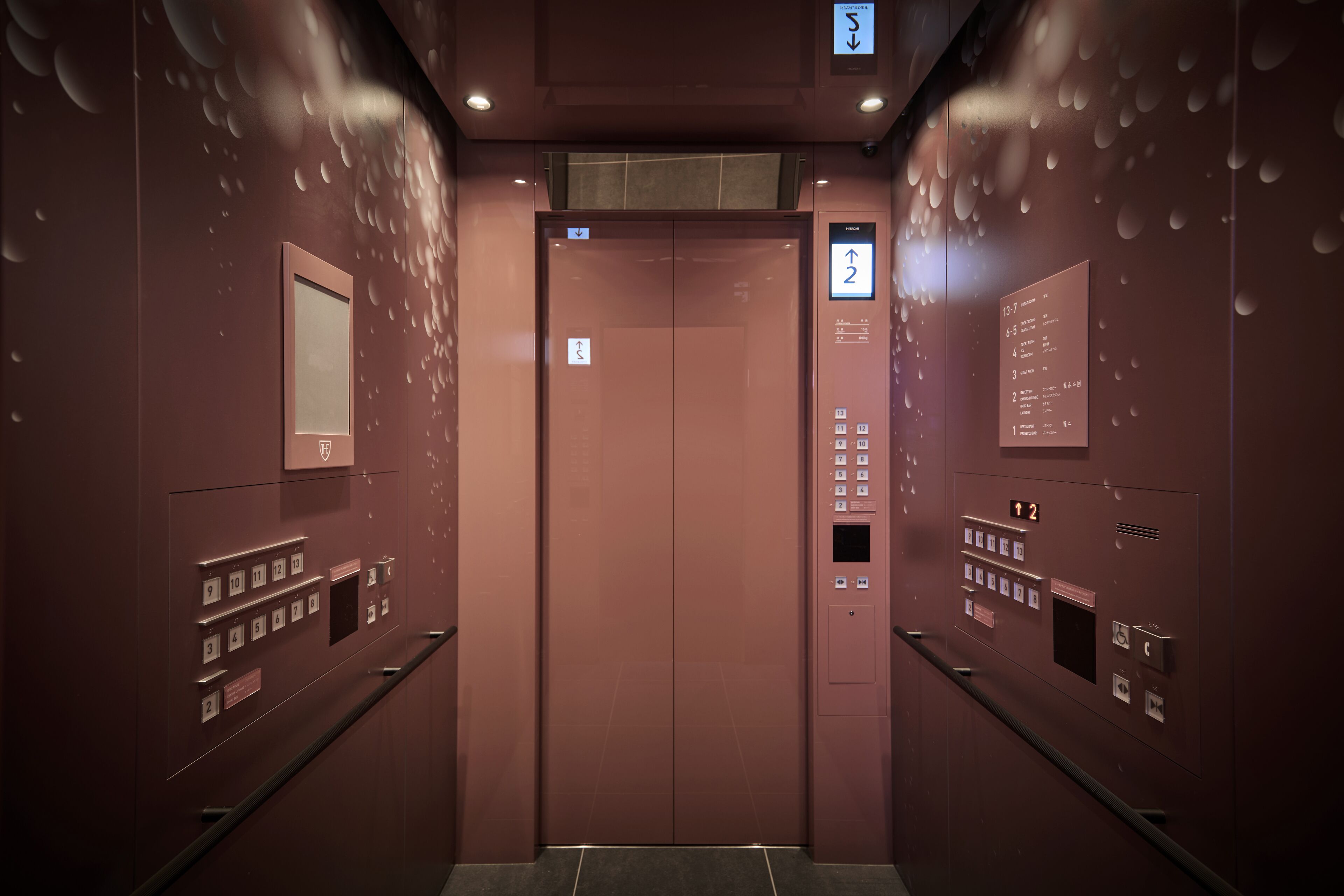 An elevator with a digital display, emergency call button, and floor selection panel.