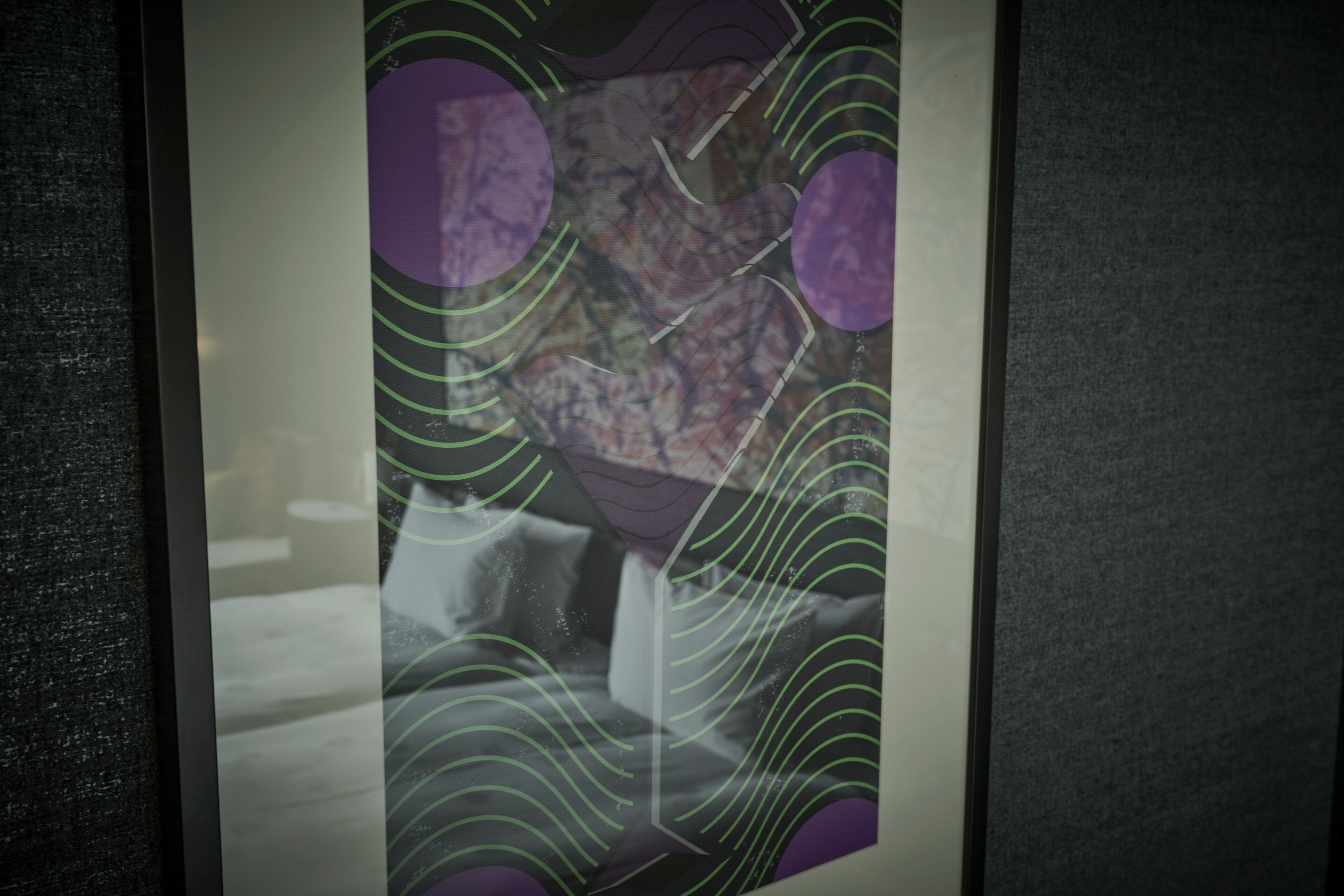 A framed abstract artwork with geometric shapes and lines.