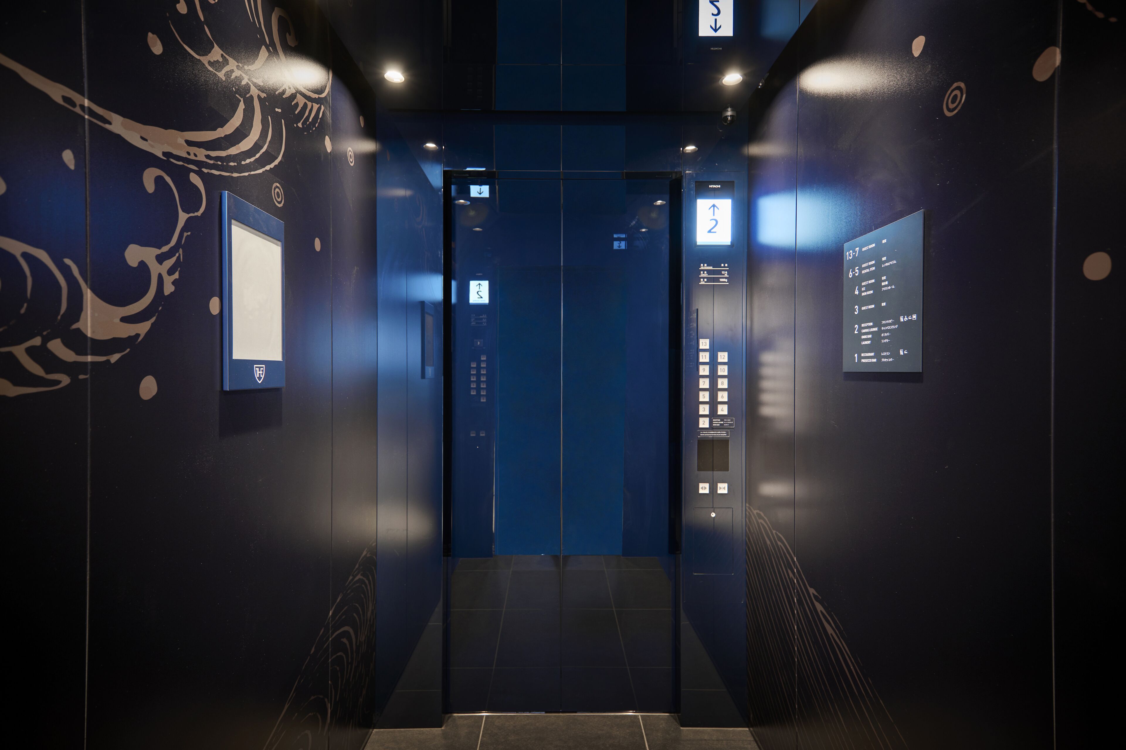 An elevator interior with digital displays showing floor numbers and times.