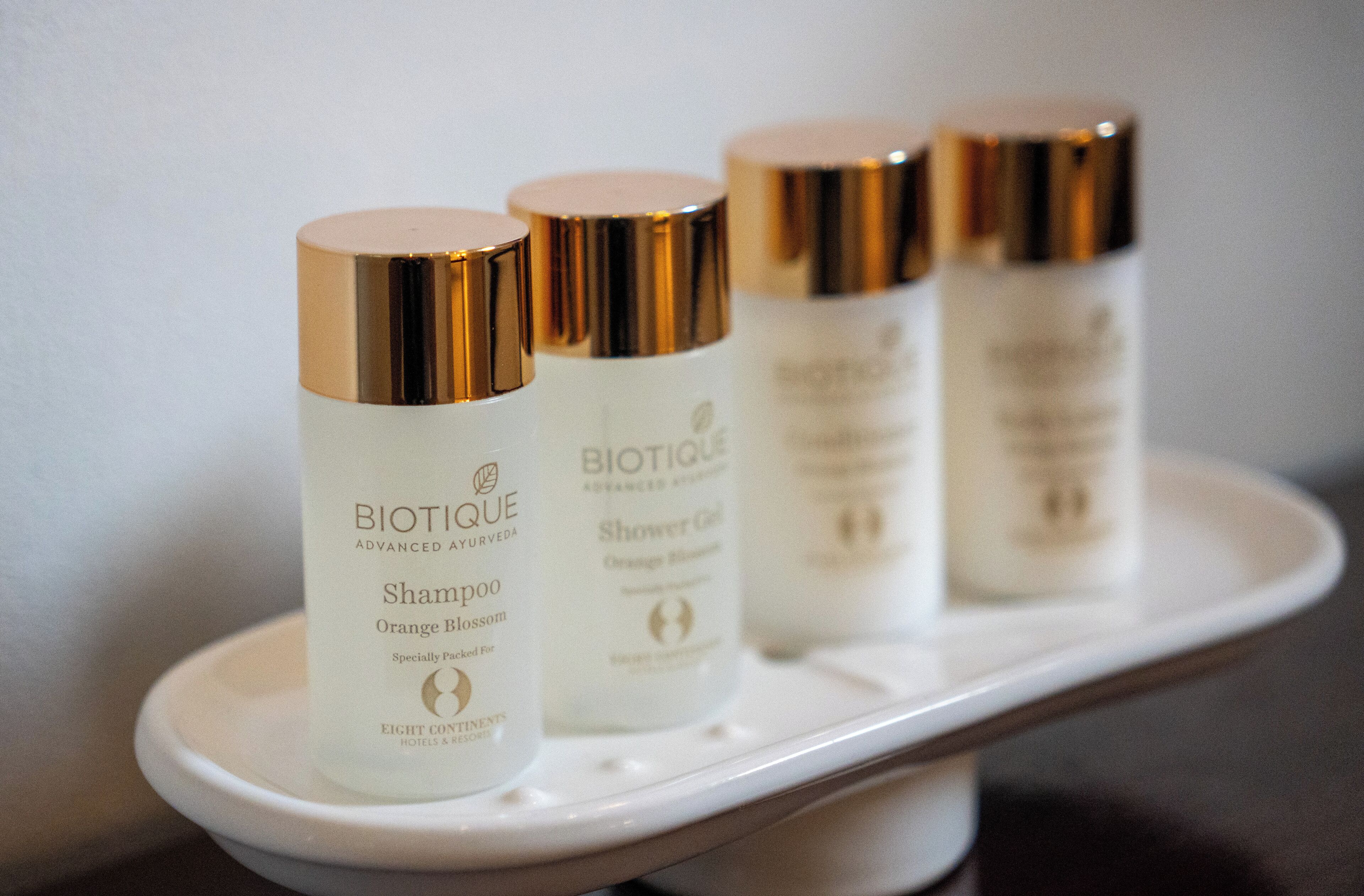Four Biotique Advanced Ayurveda shampoo bottles on a white tray.