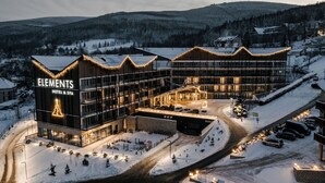 A hotel with a modern design, featuring a prominent sign and a well-lit entrance. - Elements Hotel Spa (Swieradow-Zdroj)