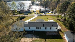 A residential area with a white house, a dock, and a lake. - Lake Murray Lake Views Galore (Prosperity)