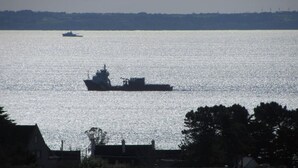 A large ship on a calm body of water with a smaller vessel in the distance. - Villa in the center of Crozon (Crozon)