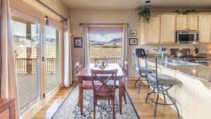 A spacious kitchen with wooden cabinets, a stainless steel sink, and a large island. - Cozy Home-Spectacular Mountain Views / ATVs Welcome (Creede)