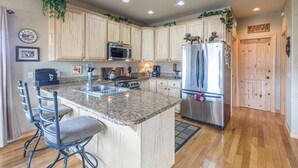A kitchen with wooden cabinets, stainless steel appliances, and a granite countertop. - Cozy Home-Spectacular Mountain Views / ATVs Welcome (Creede)