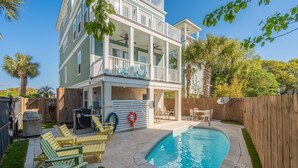 A two-story house with a pool, outdoor furniture, and a wooden fence. - Pool, ocean views from rooftop deck, one street from the beach and shops! (Isle of Palms)