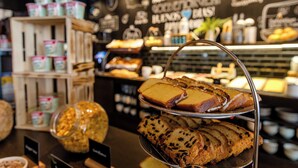 A bakery display with various baked goods and jars of ingredients. - Motel One Dublin (Dublin)