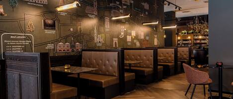 A restaurant with a map wall, booths, and a bar area.