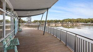 A covered deck with wooden flooring, metal railings, and benches. - Torrumbarry Motel (Torrumbarry)