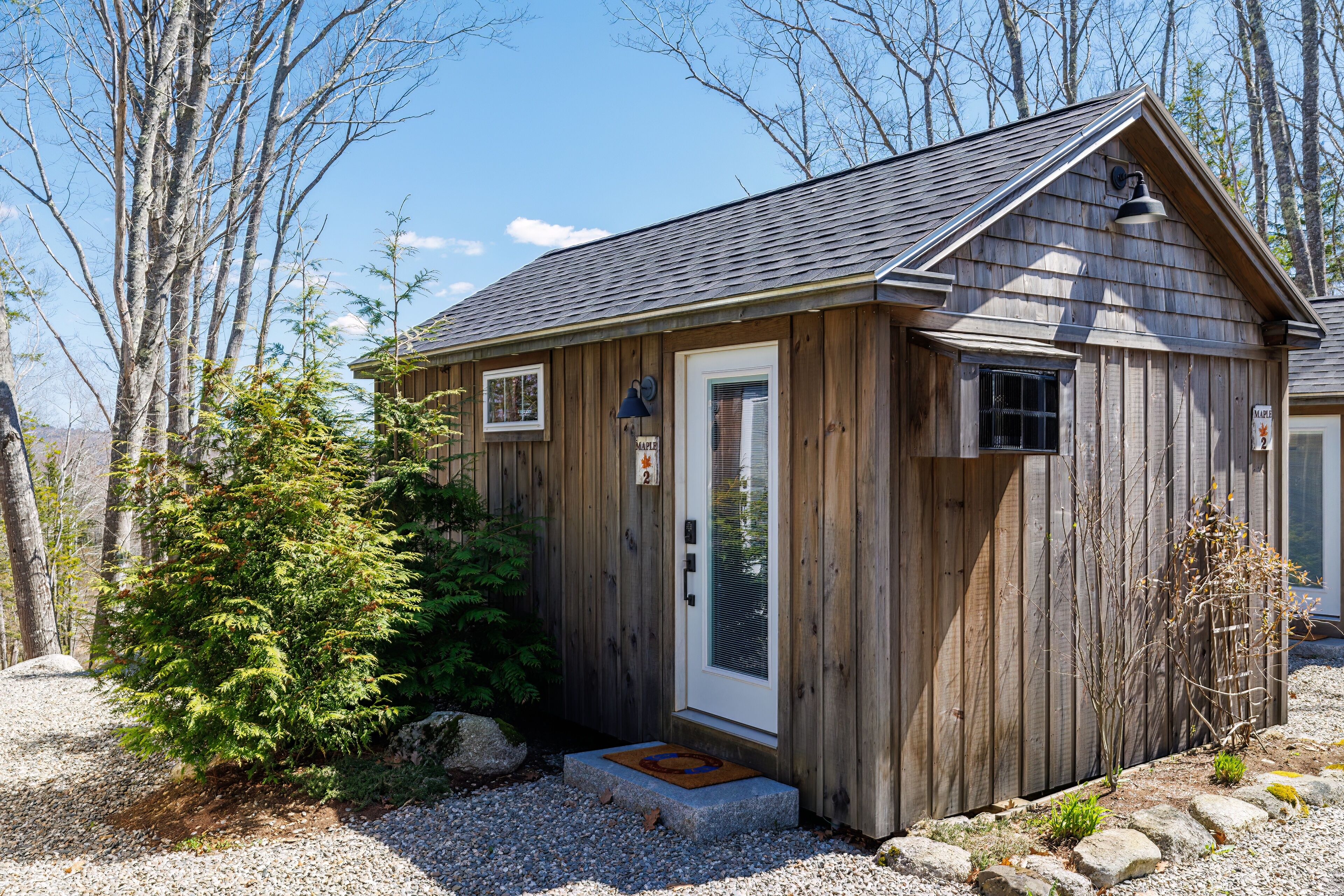 A small wooden cabin with a door, windows, and a porch.