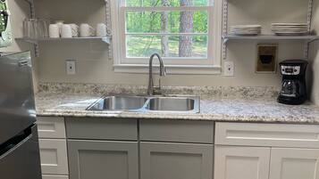 Fridge, microwave, coffee/tea maker, cookware/dishes/utensils