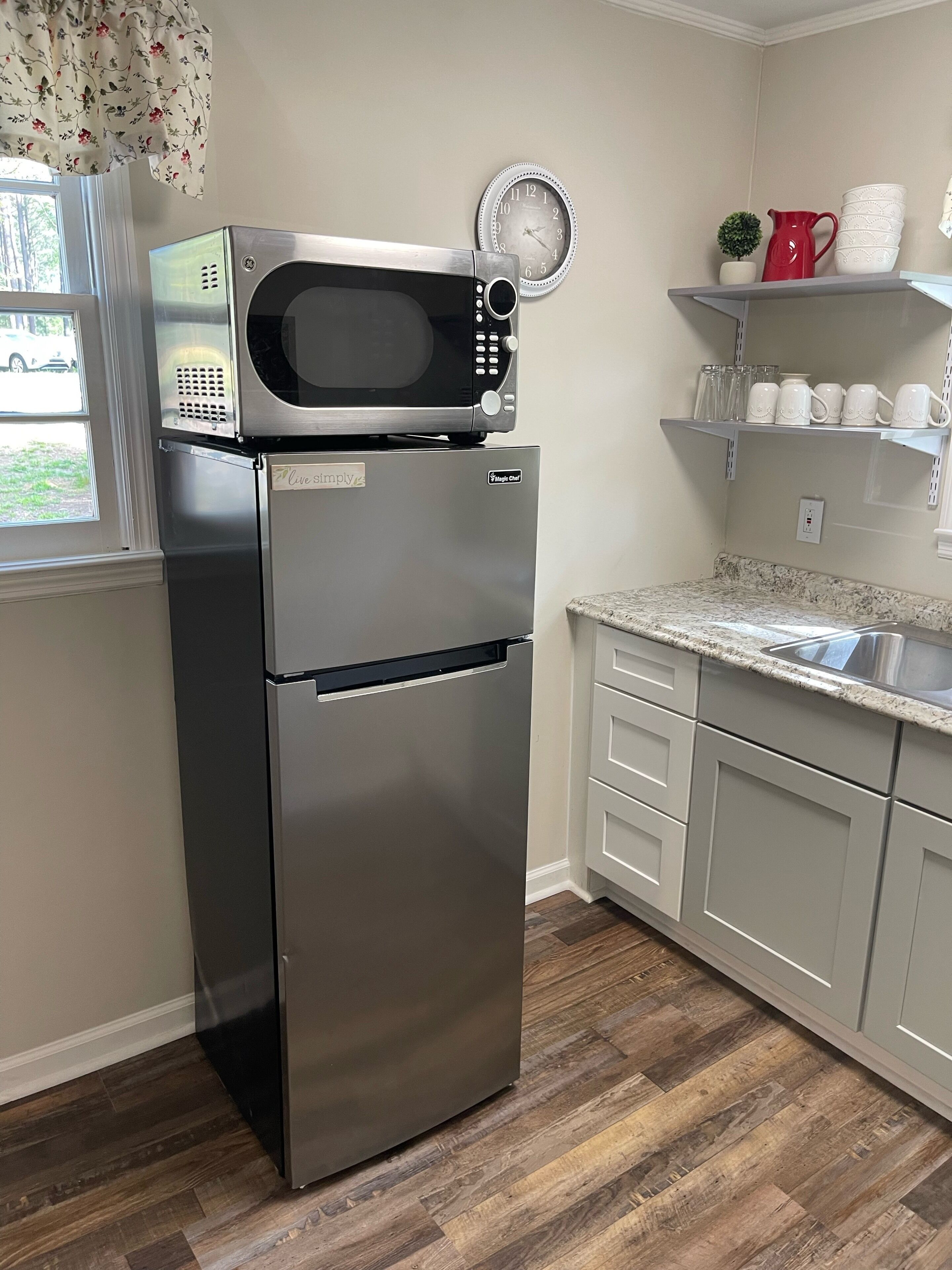 Fridge, microwave, coffee/tea maker, cookware/dishes/utensils