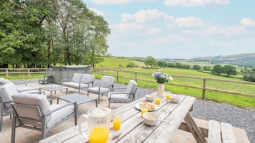 Enjoy a peaceful breakfast in our outdoor seating area, complete with a grill for a self-service meal.