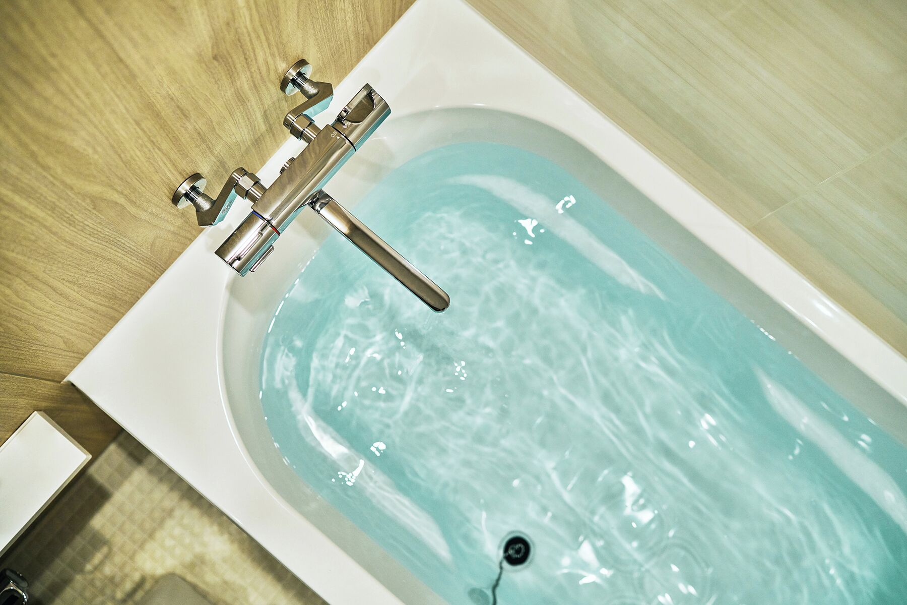 A bathtub with a faucet and a drain.